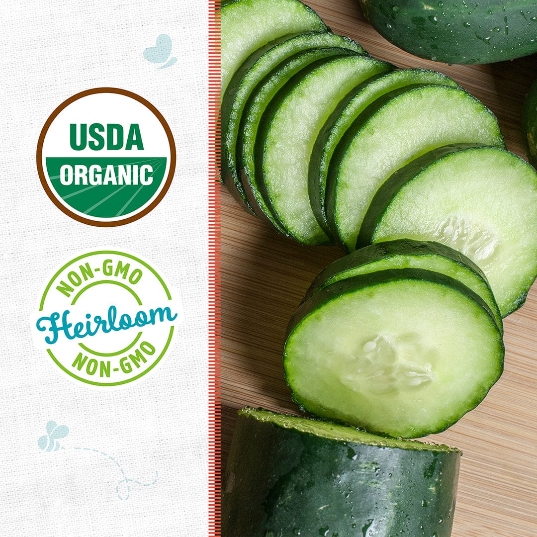 Sliced cucumber on a wooden board next to USDA Organic and Non-GMO Heirloom logos—perfect for growing with Back to the Roots Organic Cucumber Seeds 'Marketmore 76'.