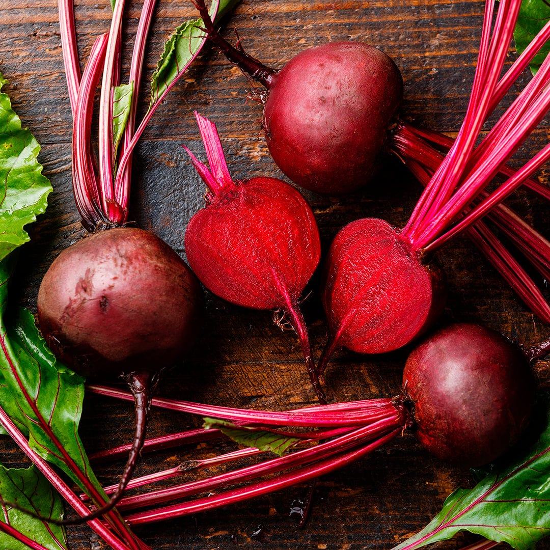Fresh Detroit Dark Red beets with vibrant red stems and deep green leaves on wooden surface. - Organic Beet Seeds — 'Detroit Dark Red' - Default Title - Back to the Roots