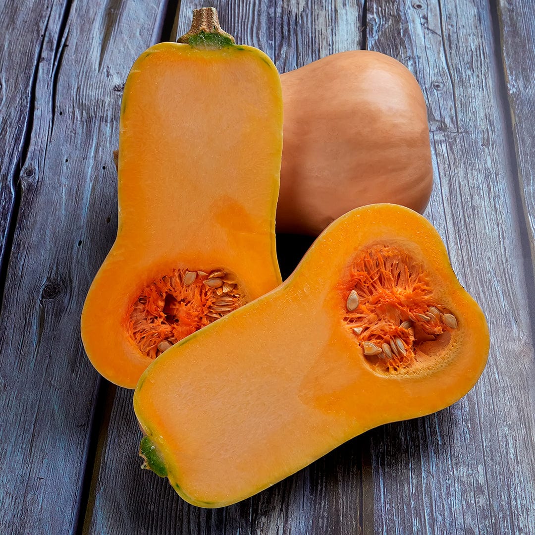 Waltham Butternut squash halved to show smooth orange flesh and seeds on rustic wooden surface. - Organic Squash Seeds — 'Waltham Butternut' - Default Title - Back to the Roots