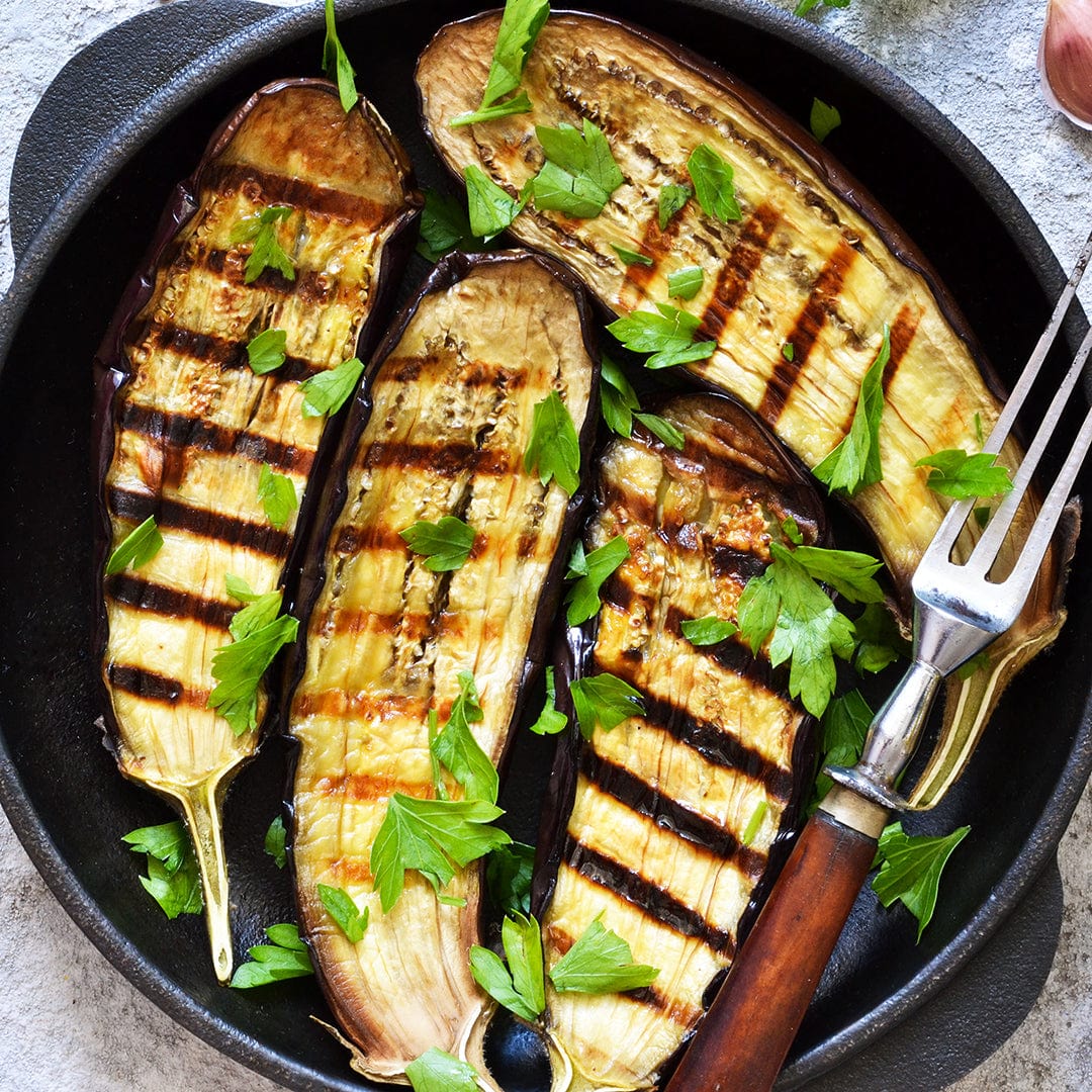 Savor homegrown flavor with grilled slices of eggplant grown from Back to the Roots Organic Eggplant Seeds — 'Black Beauty', beautifully garnished and served—proof of the delicious rewards of your own vegetable garden.