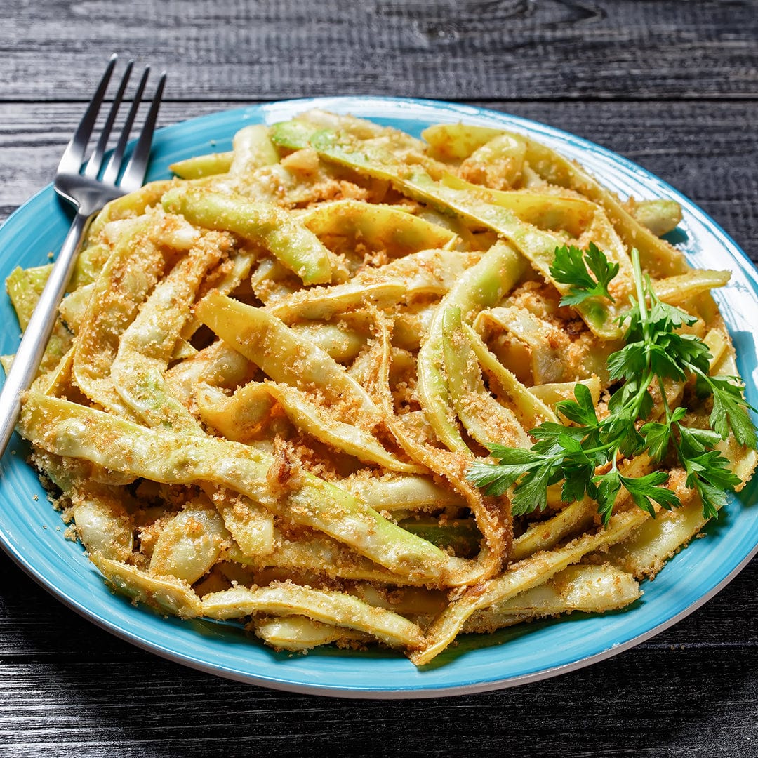Blue plate with cooked golden wax beans garnished with fresh parsley on dark wooden table. - Organic Bean Seeds — 'Golden Wax' - Default Title - Back to the Roots