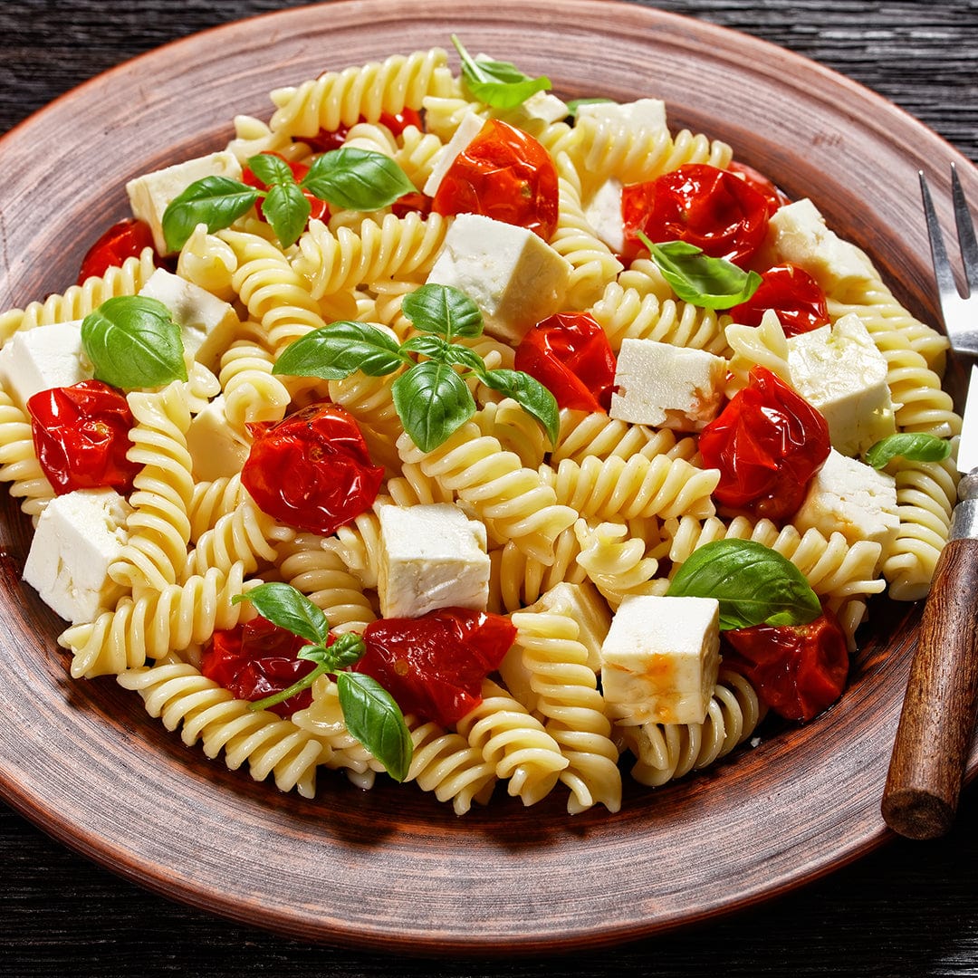 Plate of rotini pasta with roasted cherry tomatoes, basil leaves, and cubed white cheese. - Organic Basil Seeds — 'Culinary Blend' - Default Title - Back to the Roots