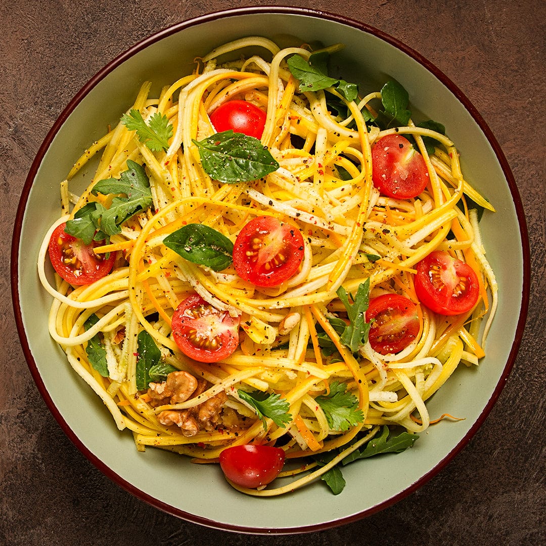 Bowl of yellow zucchini noodles with cherry tomatoes, fresh herbs, and seasoning. - Organic Zucchini Seeds — 'Golden' - Default Title - Back to the Roots