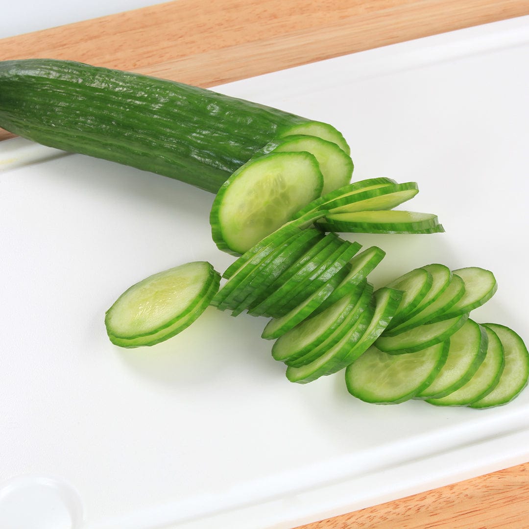 Whole and thinly sliced straight eight cucumber with dark green skin on white cutting board. - Organic Cucumber Seeds — 'Slicing • Straight Eight' - Default Title - Back to the Roots