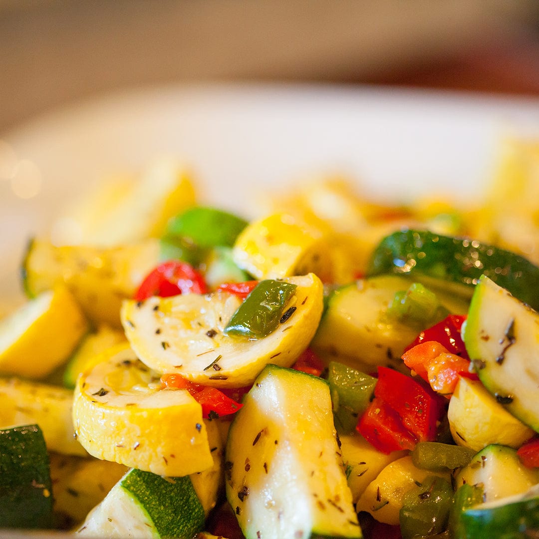 Roasted mixed squash and zucchini with red bell peppers and herbs on a white plate. - Organic Squash Seeds — 'Early Prolific Straightneck' - Default Title - Back to the Roots