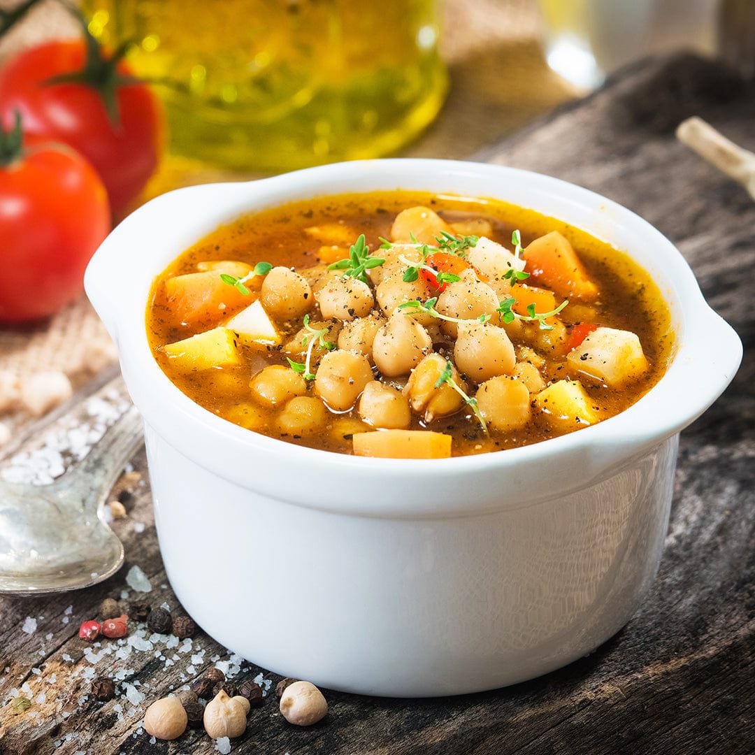 White ceramic bowl filled with chunky garbanzo bean stew garnished with herbs. - Organic Bean Seeds — 'Garbanzo' - Default Title - Back to the Roots
