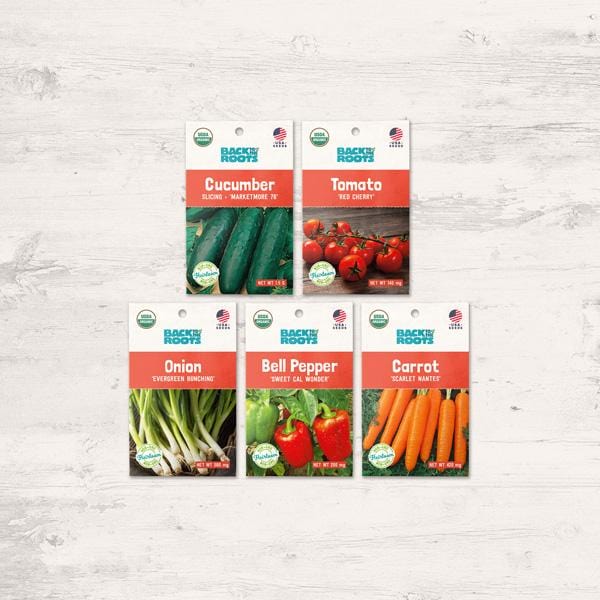 Five organic seed packets featuring cucumber, tomato, onion, bell pepper, and carrot varieties on a light wooden surface. - Organic Veggie Garden Variety Pack - Seed Pack Bundle - Default Title - Back to the Roots