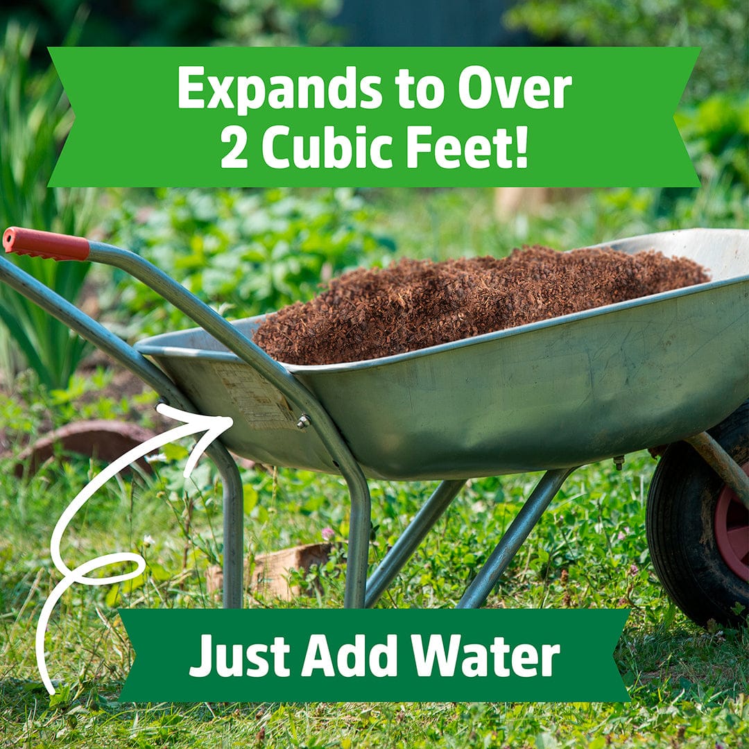 Green metal wheelbarrow filled with brown shredded coconut coir mulch on green grass background. - Organic Coconut Coir Mulch 10lb Block - Default Title - Back to the Roots
