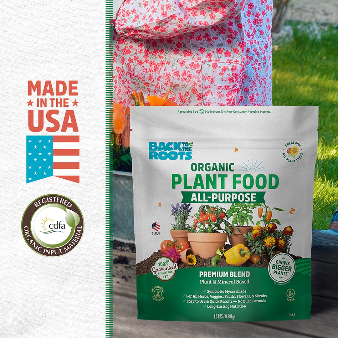A bag of Back to the Roots Natural & Organic ALL-PURPOSE Plant Food is displayed in front of a garden bed, featuring “Made in the USA” and certification logos on the left.