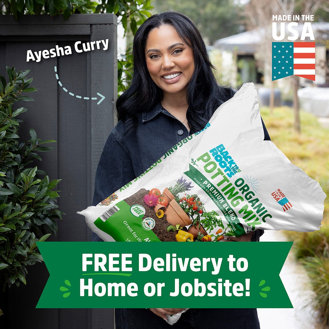 Ayesha Curry holds a large bag of Back to the Roots Organic Premium Blend Potting Mix 1 cu.ft. – 2 Pack. Text reads “FREE Delivery to Home or Jobsite!” and “Made in the USA.”.