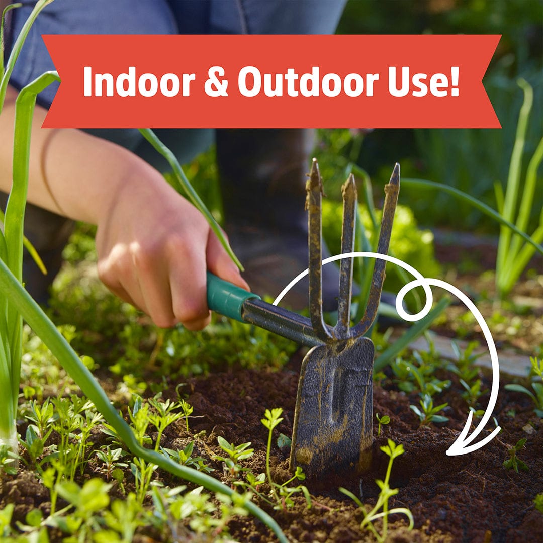 Blue-handled garden cultivator digging dark, rich soil among green plants outdoors. - Organic Worm Castings 5lb Pouch - Default Title - Back to the Roots