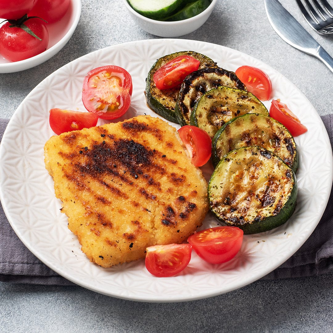 White ceramic plate with grilled golden-brown fish filet, grilled zucchini slices, and quartered cherry tomatoes on gray. - Organic Zucchini Seeds — 'Fordhook' • Summer Squash - Default Title - Back to the Roots